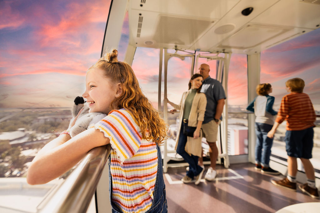 Little girl and her family taking in the sunset in The Orlando Eye capsule.