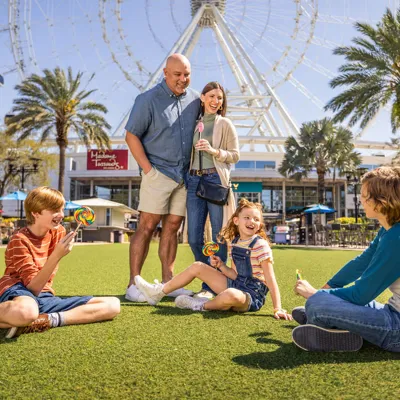 Family in front of The Orlando Eye enjoying a beautiful day